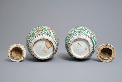 A pair of Chinese wucai jars and covers with floral design, Transitional period