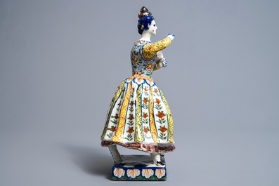 A large polychrome Dutch Delft model of a lady with a dog, 18th C.