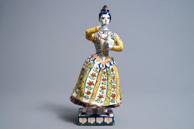 A large polychrome Dutch Delft model of a lady with a dog, 18th C.