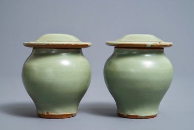 A pair of Chinese Longquan celadon vases and covers, Ming