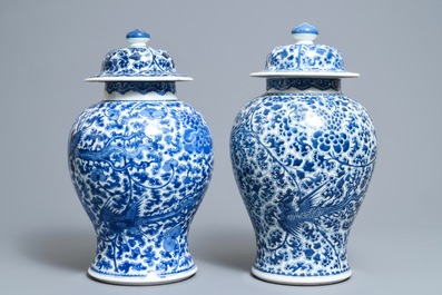 A near pair of Chinese blue and white 'phoenix' vases and covers, Kangxi