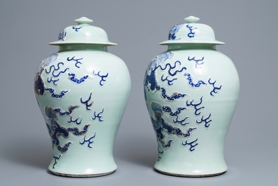 A pair of Chinese blue, white and underglaze red celadon ground vases and covers, 19/20th C.