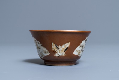 A Chinese capucin-ground grisaille and gilt cup and saucer, Qianlong