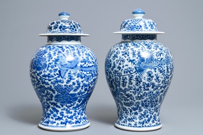 A near pair of Chinese blue and white 'phoenix' vases and covers, Kangxi