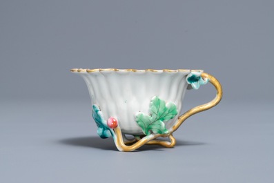 A Chinese famille rose lotus-shaped relief-decorated cup and saucer, Yongzheng