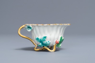 A Chinese famille rose lotus-shaped relief-decorated cup and saucer, Yongzheng