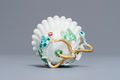 A Chinese famille rose lotus-shaped relief-decorated cup and saucer, Yongzheng