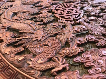 A round Chinese cinnabar lacquer plaque with two dragons, 18th C.