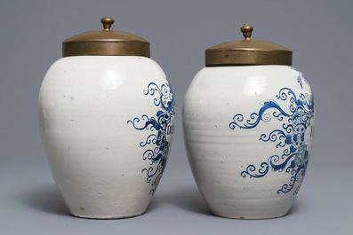 Two Dutch Delft blue and white tobacco jars with brass lids, 18th C.