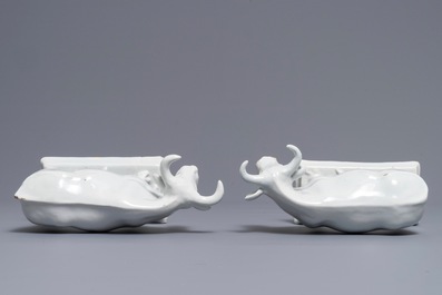 A pair of white Dutch Delft models of cows on bases with frogs, 18th C.