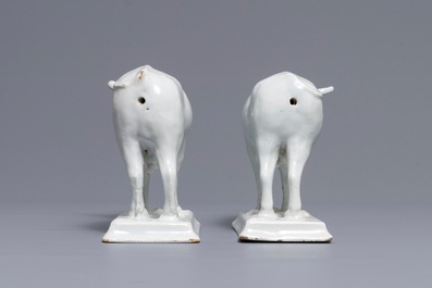 A pair of white Dutch Delft models of cows on bases with frogs, 18th C.