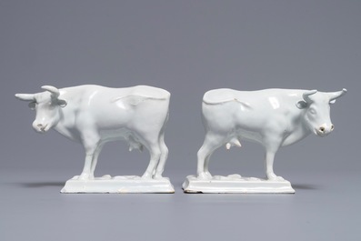 A pair of white Dutch Delft models of cows on bases with frogs, 18th C.