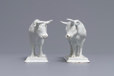 A pair of white Dutch Delft models of cows on bases with frogs, 18th C.