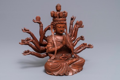 A Chinese huangyang wood figure of the 12-armed Guanyin, Republic, 20th C.