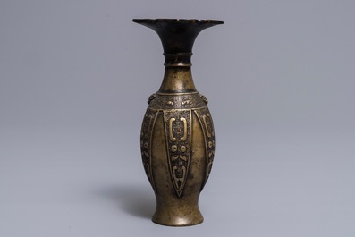 An archaic Chinese bronze lotus head vase, 17/18th C.