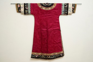 A Chinese informal Manchu embroidered silk pink-ground women's robe, 19th C.