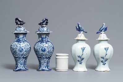 Two pairs of Dutch Delft blue and white covered vases and a drug jar, 18th C.