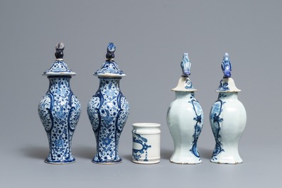 Two pairs of Dutch Delft blue and white covered vases and a drug jar, 18th C.