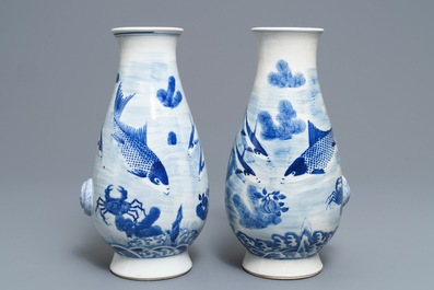 A pair of Chinese blue and white 'fish and crab' vases, Kangxi mark, 19th C.