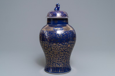 A Chinese powder blue-ground and gilt vase and cover, Kangxi mark, 19/20th C.