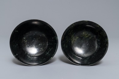 A pair of dark spinach green jade bowls with Arabic or Urdu inscriptions, India, 19/20th C.