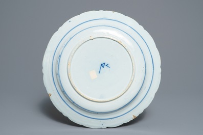 Two Dutch Delft blue and white chargers, an oval dish and a vase, 18th C.