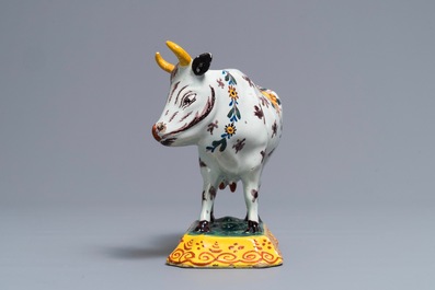 A polychrome Dutch Delft cow on base with frogs, 18th C.