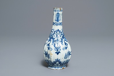 Two Dutch Delft blue and white chargers, an oval dish and a vase, 18th C.