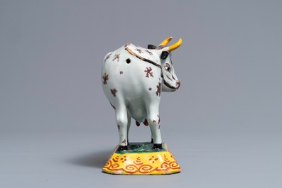 A polychrome Dutch Delft cow on base with frogs, 18th C.