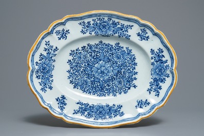 Two Dutch Delft blue and white chargers, an oval dish and a vase, 18th C.