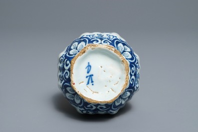 Two Dutch Delft blue and white chargers, an oval dish and a vase, 18th C.