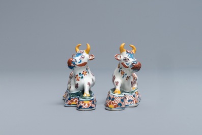 A pair of polychrome Dutch Delft models of recumbent cows, 18th C.