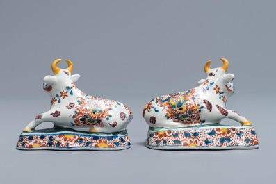 A pair of polychrome Dutch Delft models of recumbent cows, 18th C.