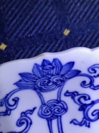 A Chinese blue and white moulded plate with figures on a terrace, Kangxi mark and of the period