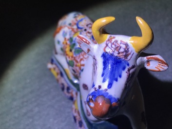 A pair of polychrome Dutch Delft models of recumbent cows, 18th C.