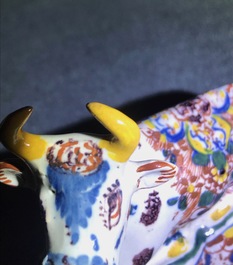 A pair of polychrome Dutch Delft models of recumbent cows, 18th C.