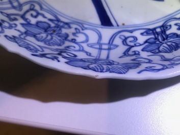 A Chinese blue and white moulded plate with an amorous couple, Kangxi mark and of the period