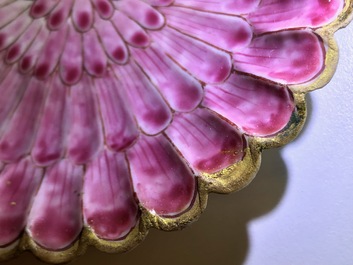 A Chinese famille rose lotus-shaped relief-decorated cup and saucer, Yongzheng