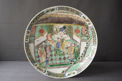 A Chinese famille verte charger with figures in an interior, Kangxi