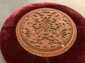 A round Chinese cinnabar lacquer plaque with two dragons, 18th C.