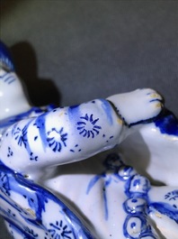 A pair of Dutch Delft blue and white models hurdy-gurdy players, 18th C.