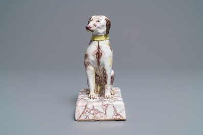 Een Brussels aardewerken model van een hond in mangaan en geel, 18e eeuw