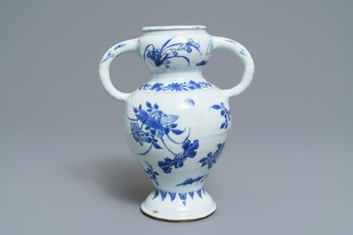 A Chinese blue and white elephant-handled vase with floral design, Transitional period