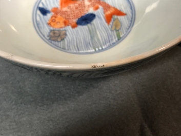 A Chinese doucai bowl with fish in a lotus pond, Xuande mark, Kangxi