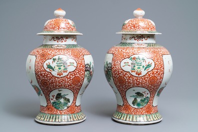 A pair of Chinese famille verte vases and covers, 19th C.