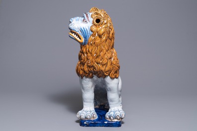 A massive French faience model of a lion, Rouen, 19th C