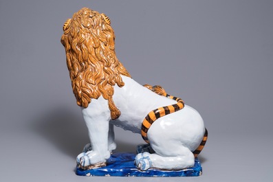 A massive French faience model of a lion, Rouen, 19th C