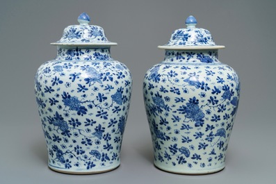 A pair of Chinese blue and white covered vases with floral design, Kangxi