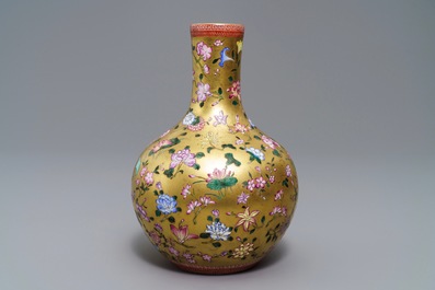 A Chinese famille rose gilt-ground bottle vase with floral design, Qianlong mark, 19/20th C.