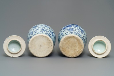 A pair of Chinese blue and white covered vases with floral design, Kangxi